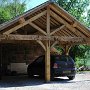 A typical oak framed slate roofed two bay garage, open sided.